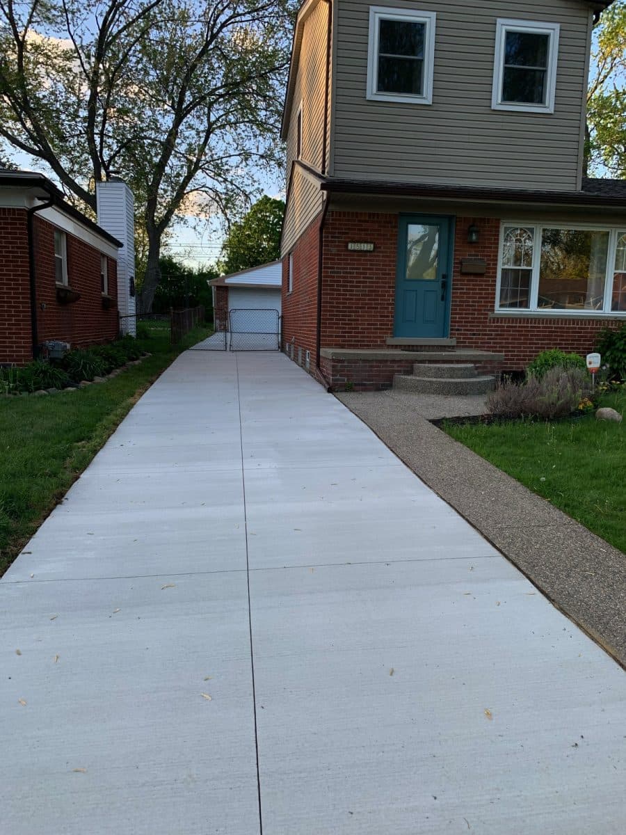 Concrete driveway with decorative stamped border in Dorchester, ON